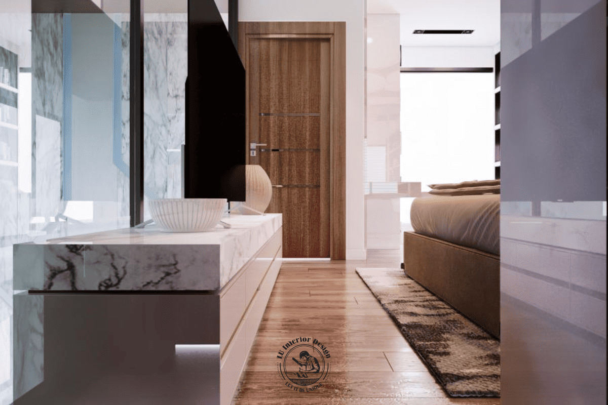 Khu vực kệ tivi đối diện giường sử dụng đá ốp vân mây bề mặt và hệ tủ ngăn kéo phía dưới, liên kết trực tiếp với lối giao thông chính của phòng ngủ