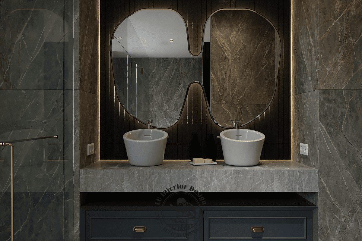 Khu vực lavabo đôi sở hữu chiếc gương có hình dáng nghệ thuật và hệ tủ dưới màu xanh đen tối giản
