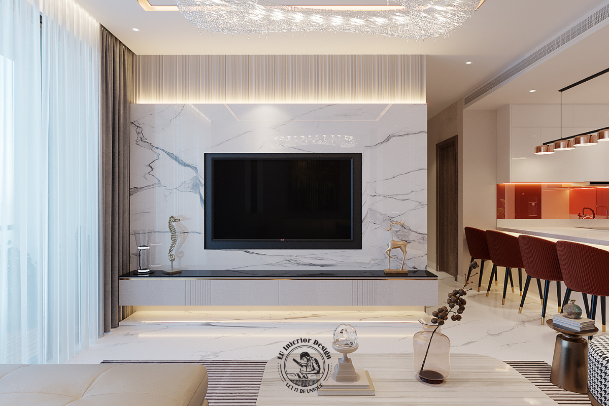 Hệ vách ốp đá marble vân mây kéo dài từ sàn lên tường là điểm nhấn ấn tượng, mang lại sự sang trọng đồng nhất cho toàn bộ khu vực kệ tivi.